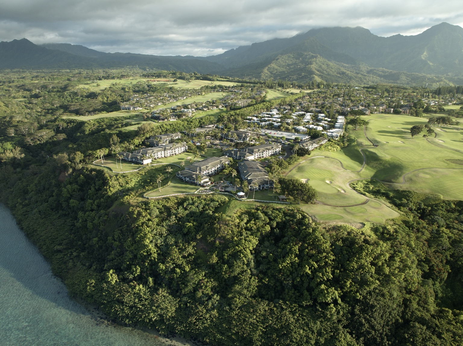 Aerial landscape with coastline, golf course and mountains